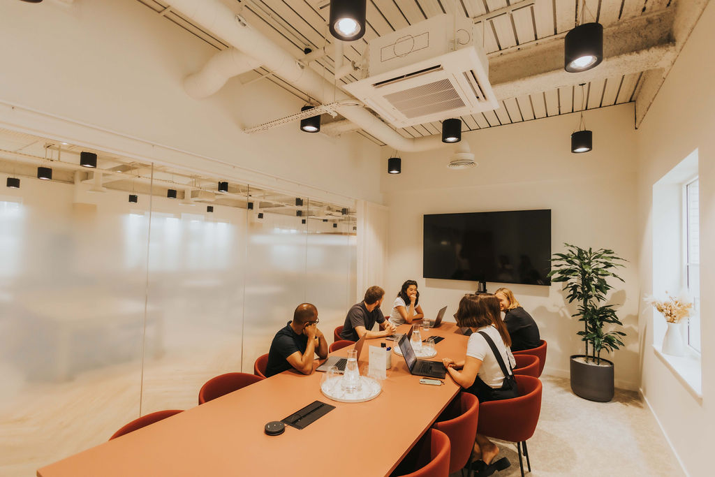 Team meeting in a glass-fronted meeting room at Vallist Finlaison House, Holborn