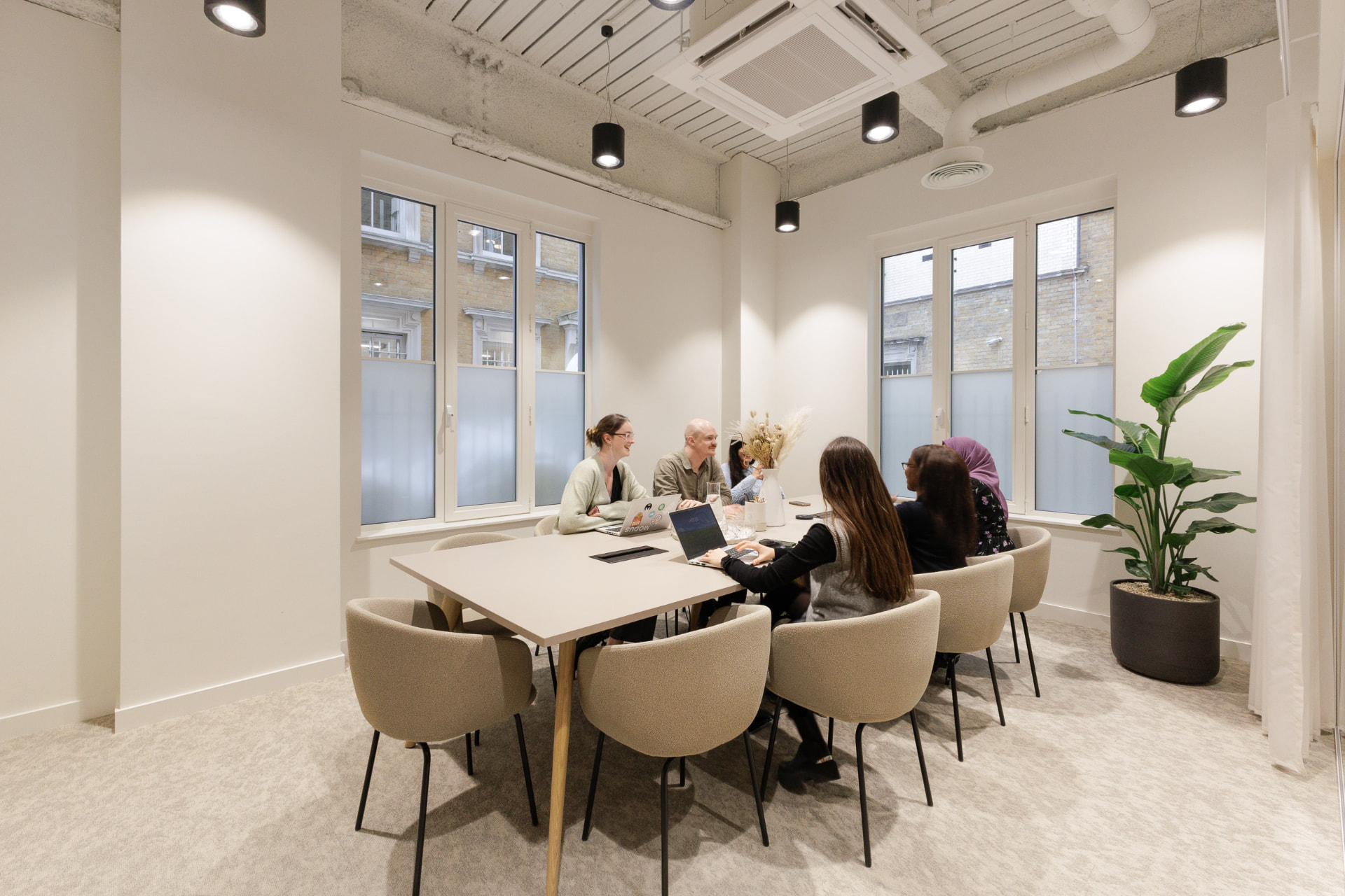 Members working around a shared table in a bright room at Vallist Finlaison House, Holborn