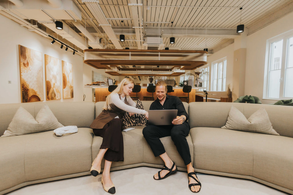 Two people working together in the Finlaison House lounge