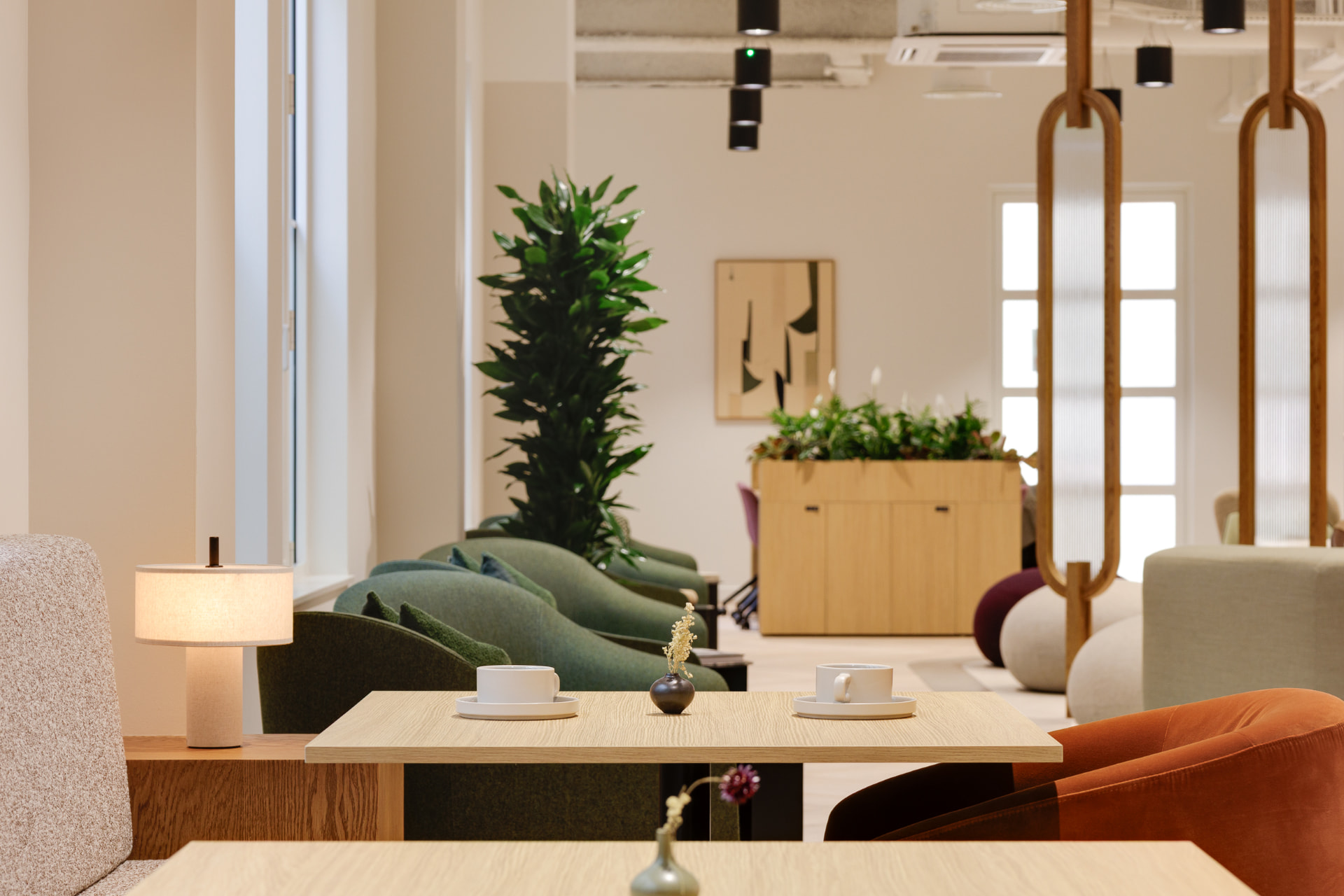 Soft seating and oak tables in the café lounge at Vallist Finlaison House, Holborn